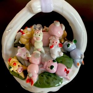 Whimsical ceramic pigs in a basket